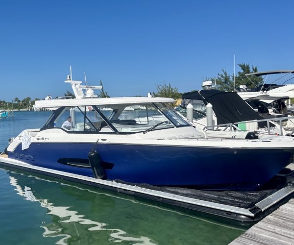 Luxury boat docked in clear water.