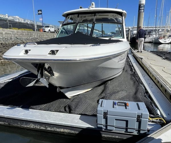 Boat docked at marina with equipment