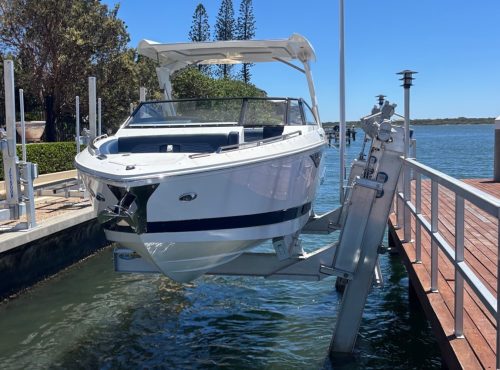 Boat on boat lift near waterway